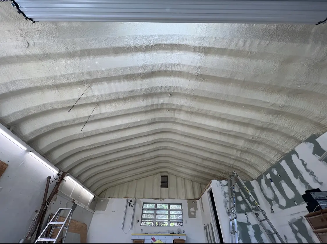 Spray polyurethane foam applied to the underside of a metal roof deck in Town of Pecos